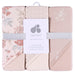 Just Born hooded baby towels three-pack with floral patterns and soft pink hues, neatly packaged.