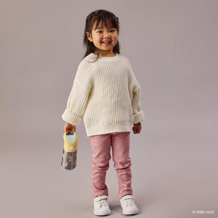 b.box insulated water bottle Looney Tunes held by a smiling child in casual clothes standing indoors.
