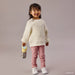 b.box insulated water bottle Looney Tunes held by a smiling child in casual clothes standing indoors.