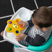 b.box Pop & Glow Starfish Sensory Toy held by a baby in a high chair