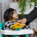 b.box Pop & Glow Starfish sensory toy placed on a highchair tray in front of a smiling baby