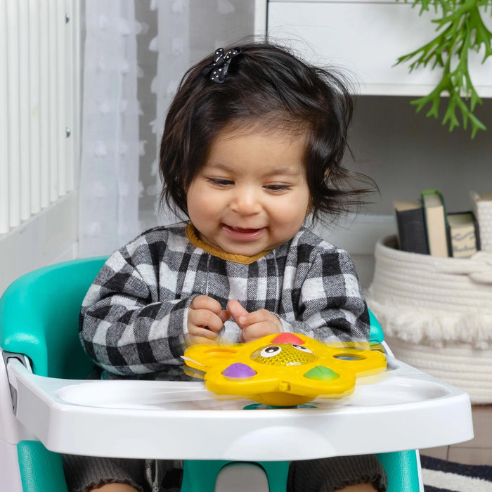 b.box Pop & Glow Starfish Sensory Toy on highchair tray with smiling baby playing indoors
