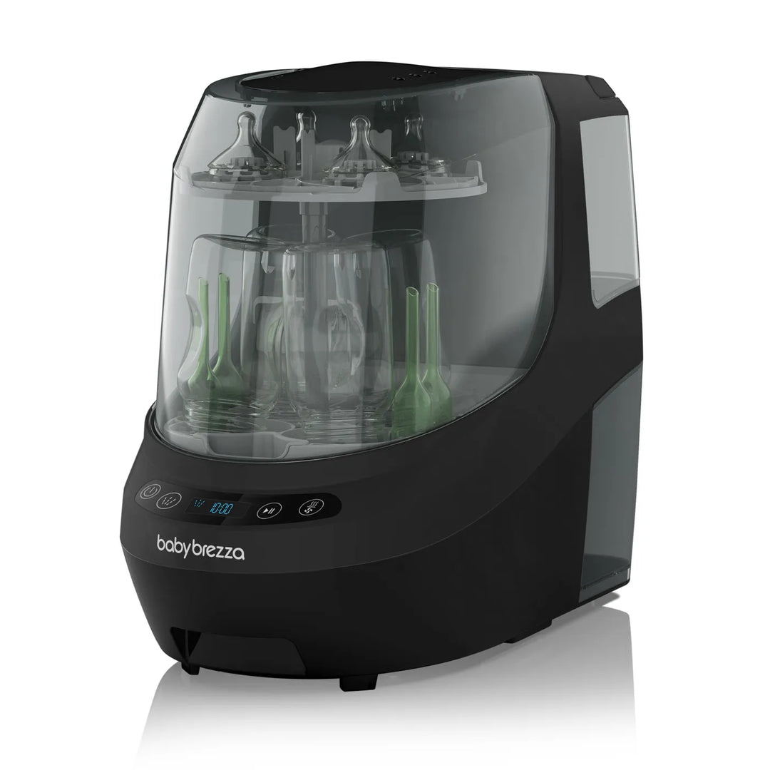Baby Brezza bottle washer in black shown on a plain surface with bottles and nipples inside