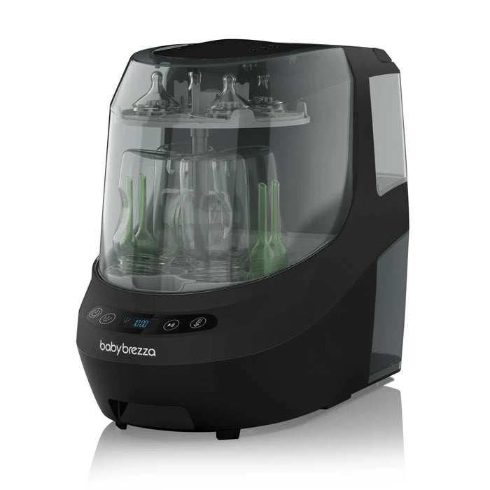 Baby Brezza bottle washer in black shown on a plain surface with bottles and nipples inside