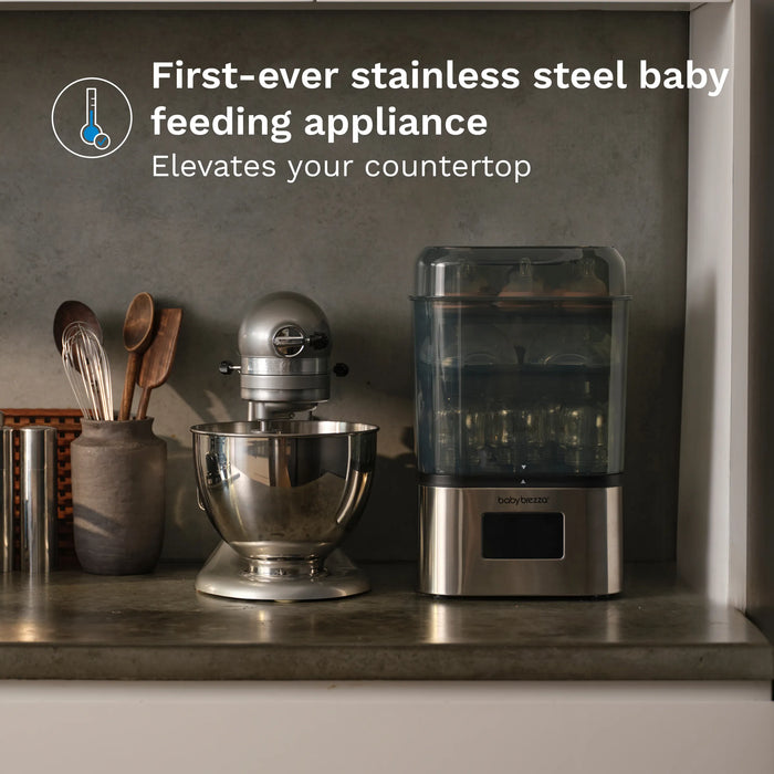 Baby Brezza Super Fast Sterilizer and Dryer stainless steel on a modern kitchen countertop.
