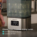 Baby Brezza Super Fast Sterilizer and Dryer with digital display sterilizing bottles on a kitchen counter.