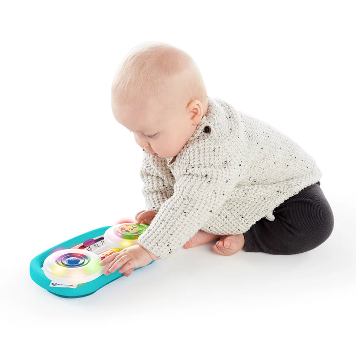 Baby Einstein Toddler Jams Musical Toy with lights being played by a baby on a white background.