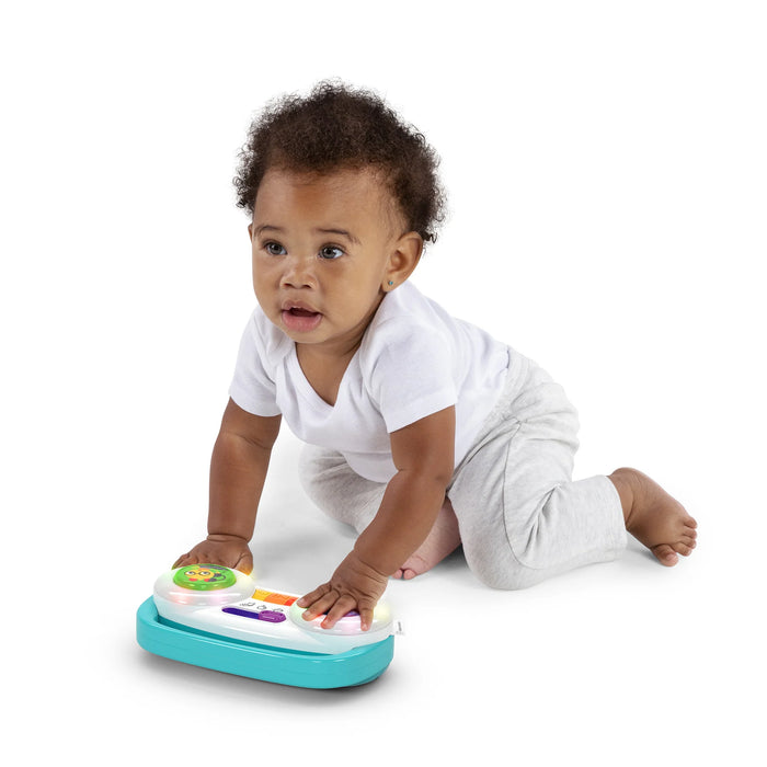 Baby Einstein Toddler Jams Musical Toy being played with by a crawling baby on a white background.