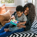 Baby Einstein Toddler Jams musical toy played by a child on a parent's lap in a cozy room.