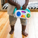 Baby Einstein Toddler Jams musical toy held by a child standing on a wooden floor.