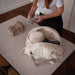 Baby on Board doudoune cotton diaper bag open on a table, being packed by a woman in a white shirt.