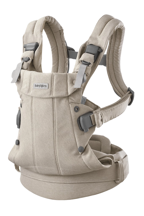BabyBjorn Baby Carrier Harmony in beige shown upright on a plain background.