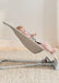 BabyBjorn Bouncer Bliss 3D Mesh in light beige with a baby lying comfortably on a carpeted floor.
