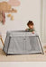 BabyBjorn Play Yard Light in silver with a toddler standing inside in a cozy nursery setting.