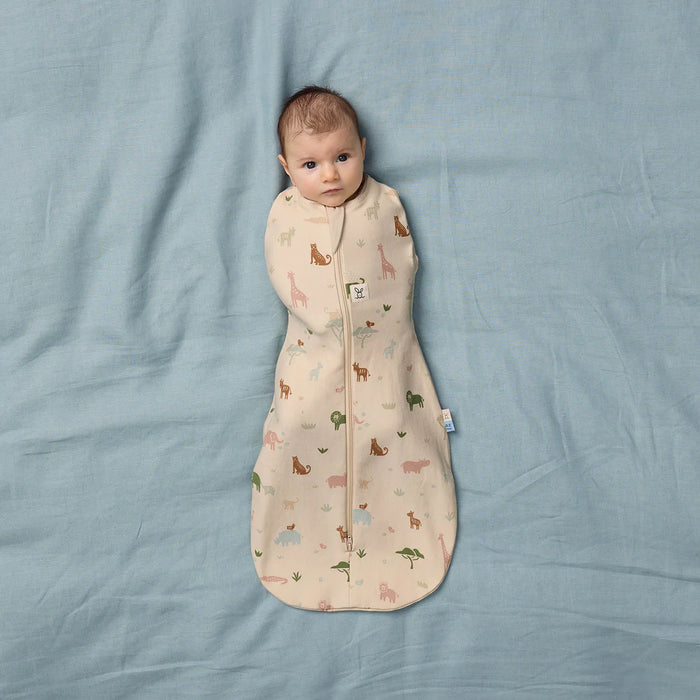 Bbox Cocoon Swaddle Sac 0.2 TOG with animal print, baby lying on light blue bedding.