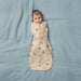 Bbox Cocoon Swaddle Sac 0.2 TOG with animal print, baby lying on light blue bedding.