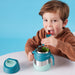 bbox insulated food jar 335ml emerald forest held by a child at a table, eating with a utensil