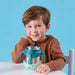 b.box insulated food jar 335ml emerald forest held by a smiling child at a table