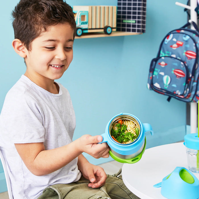 Bbox insulated food jar 335ml Ocean Breeze held by a child at a small table with pasta inside.
