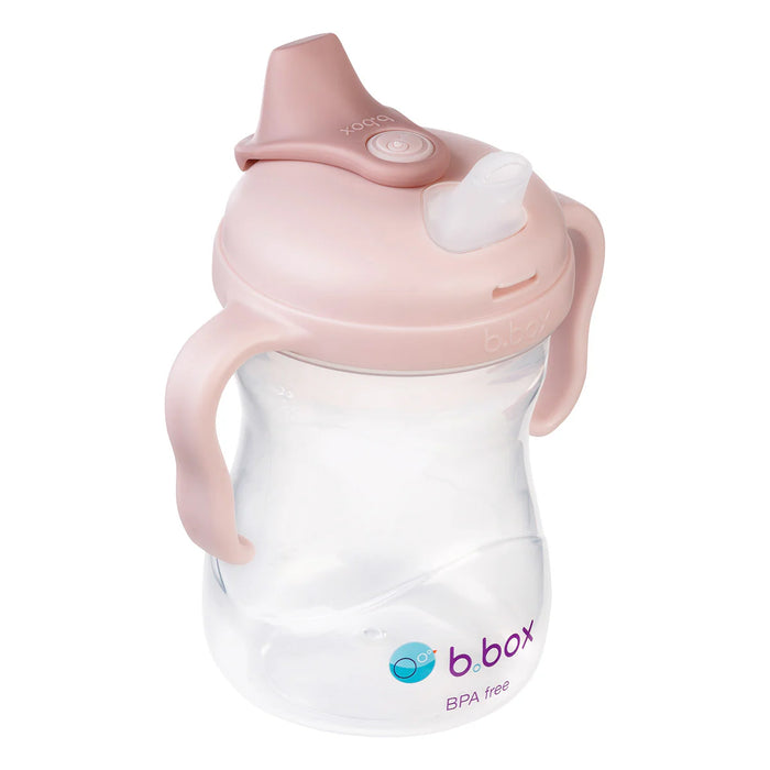 bbox silicone sippy cup in blush color shown close-up with ergonomic handles and clear base