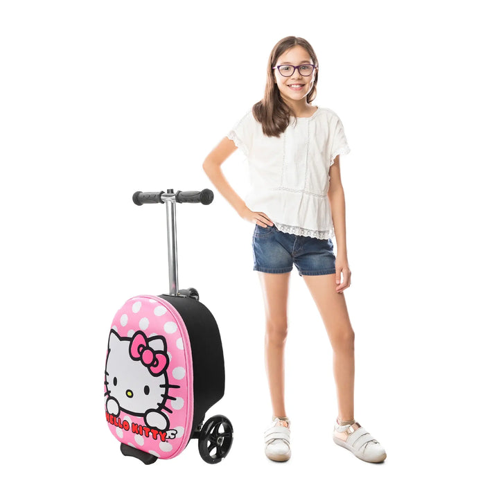 Bioworld Hello Kitty polka dot pink scooter luggage shown beside a smiling girl in casual outfit.
