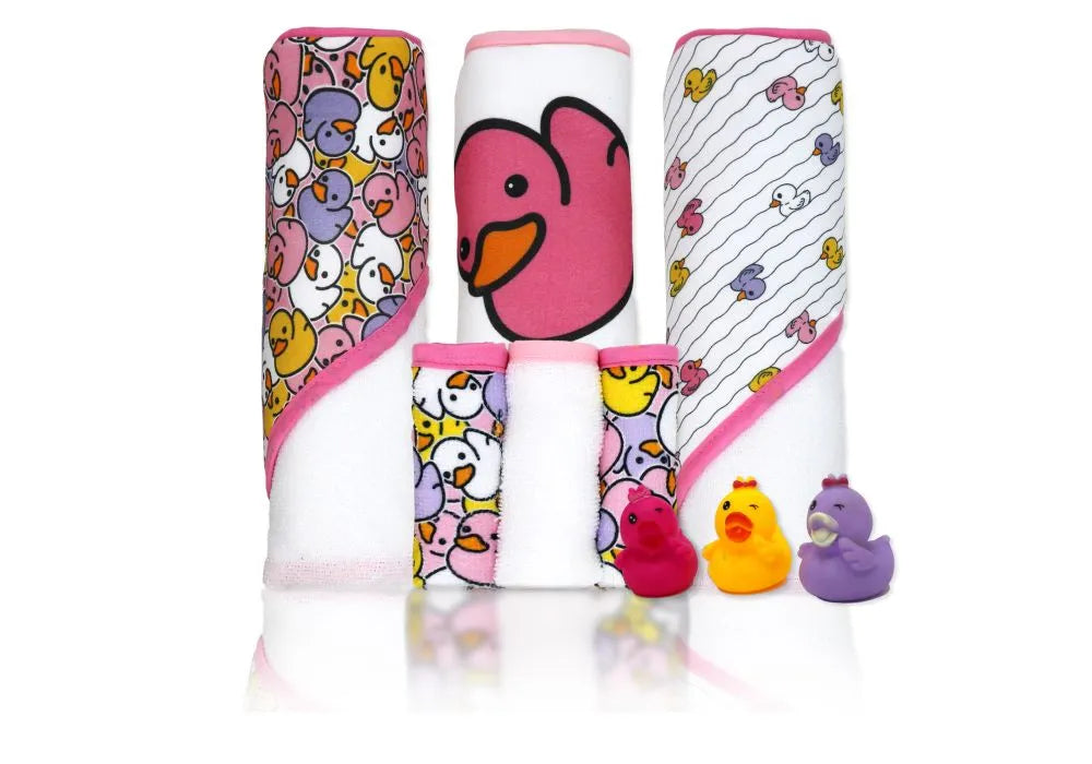Baby hooded towels and washcloths with colorful duck prints, and three rubber duck bath toys