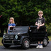Mercedes Maybach G 650 kids ride-on car with two children outdoors on a sunny day.