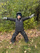 Conifere Ginko Snowsuit in charcoal, worn by a child standing with arms outstretched outdoors.