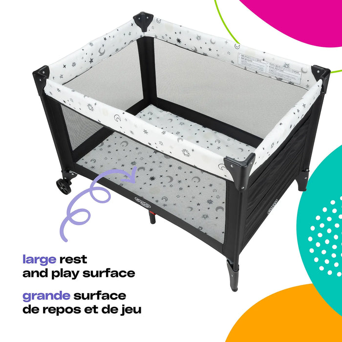 Cosco Funsport Playard shown in a room, featuring mesh sides and a star and moon patterned design.