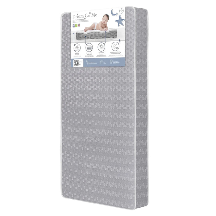 Dream On Me 2-in-1 breathable slumber crib mattress standing upright with product label visible.