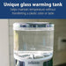 Dr. Brown's Insta-Prep warm water dispenser with glass tank shown on a kitchen counter.