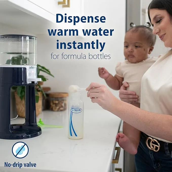 Dr. Brown’s Insta-Prep warm water dispenser on kitchen counter with parent preparing baby bottle.