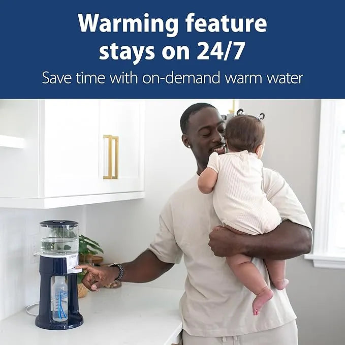 Dr. Brown's Insta-Prep warm water dispenser on a kitchen counter with a parent holding a baby nearby.