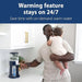 Dr. Brown's Insta-Prep warm water dispenser on a kitchen counter with a parent holding a baby nearby.