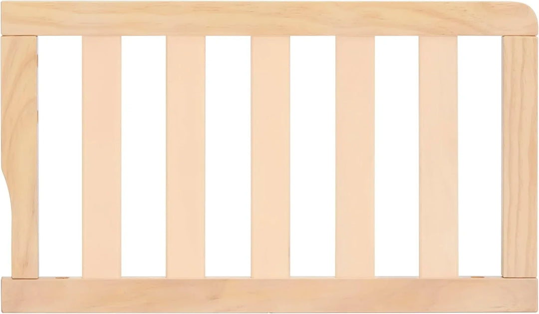 Natural wood toddler bed guard rail with vertical slats on white background