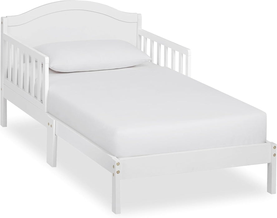 White wooden toddler bed with safety rails and pillow, ideal for kids bedroom
