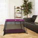 Dream On Me Travel Light pink playard set up in a bright living room with wood flooring.