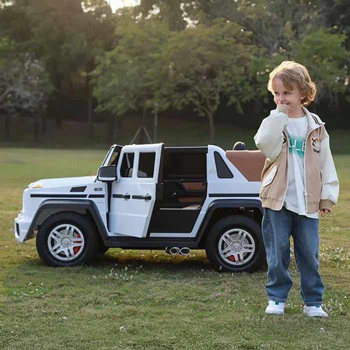 Ride-on toy car with open door shown outdoors on grass beside a smiling child in casual clothes.