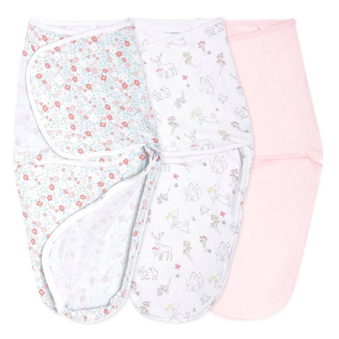 Set of three baby swaddle blankets in floral, animal, and solid pink patterns