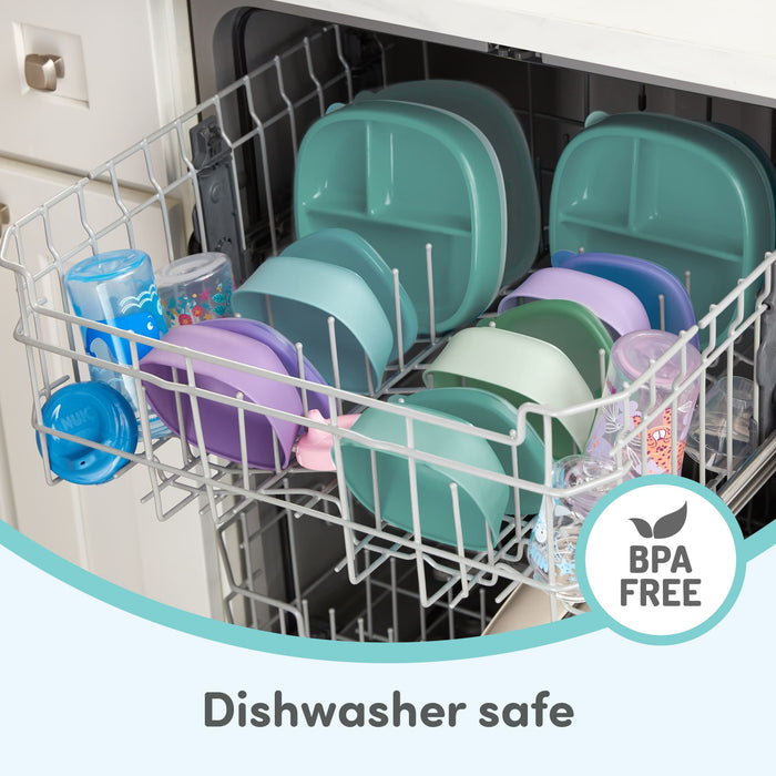 Assorted BPA-free baby plates, bowls, and cups stacked in a dishwasher for easy cleaning.