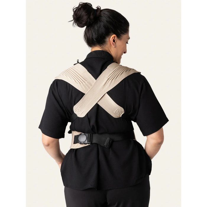 Flybaby 3D baby carrier shown from the back on a person wearing black clothes, highlighting cross-back straps.