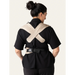 Flybaby 3D baby carrier shown from the back on a person wearing black clothes, highlighting cross-back straps.