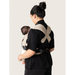 Flybaby 3D baby carrier with beige straps shown worn by a woman holding a baby from the back view.