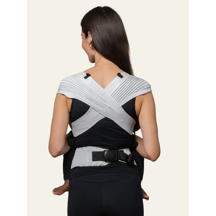 Flybaby 3D baby carrier in gray, shown from the back worn by an adult carrying a child.