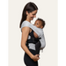 Flybaby 3D baby carrier worn by a woman carrying an infant in a front-facing position
