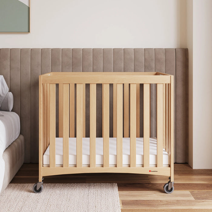 Foundations® - Foundations Travel Sleeper® Compact HideAway™ EasyRoll™ Solid Wood Folding Crib, Slatted with Oversized Casters (Including Foam Mattress)