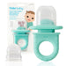 Frida Baby Push Pop Feeder in turquoise shown with packaging and included silicone feeder insert.