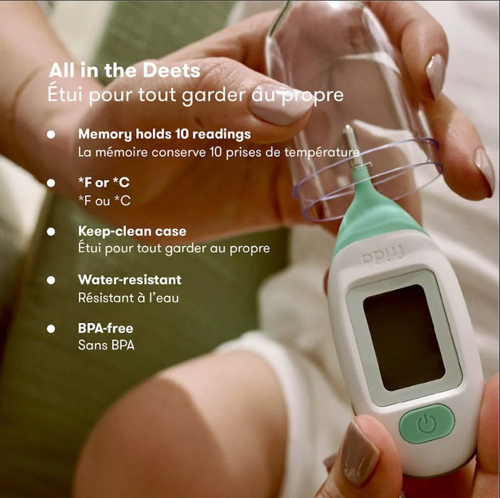 Frida Baby Quick-Read Rectal Thermometer held in a hand beside a clear protective case.
