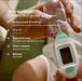 Frida Baby Quick-Read Rectal Thermometer held in a hand beside a clear protective case.