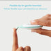 Frida Baby Quick-Read Rectal Thermometer with flexible tip shown bending on a fingertip.